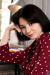 Black haired teen Naja loses her outfit and rubs her delicious muff