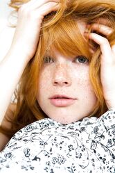 Czech ginger Mia Sollis showcases her medium tits and spreads her bald beaver