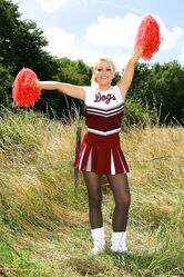 Gorgeous cheerleader Tess reveals her saggy tits and poses half naked outside