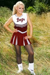 Gorgeous cheerleader Tess reveals her saggy tits and poses half naked outside