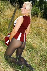 Gorgeous cheerleader Tess reveals her saggy tits and poses half naked outside