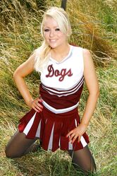 Gorgeous cheerleader Tess reveals her saggy tits and poses half naked outside
