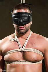 Sexy domme in a latex outfit Beretta James abuses a masked slave's cock