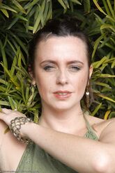 Alluring big boobed MILF Katiana gets nude in the garden and massages her clit