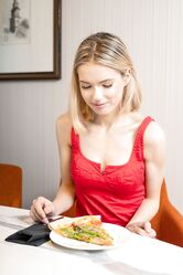 Young blonde Samara removes a red dress while staring down a slice of pizza