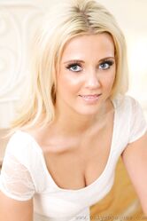Blonde babe Becki H strips her dress to pose in her tights & leather jacket