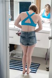 Sweet teen with small boobs Annika gets spied on while dressing in the toilet