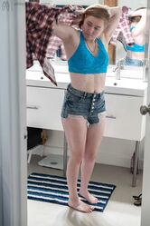 Sweet teen with small boobs Annika gets spied on while dressing in the toilet