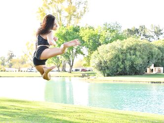 Teenage hottie in sexy outfit Zoe doing exercise outdoors by the water