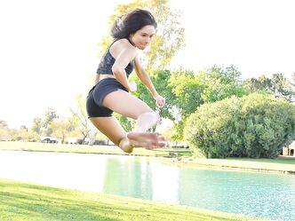 Teenage hottie in sexy outfit Zoe doing exercise outdoors by the water