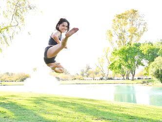 Teenage hottie in sexy outfit Zoe doing exercise outdoors by the water