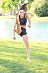 Teenage hottie in sexy outfit Zoe doing exercise outdoors by the water