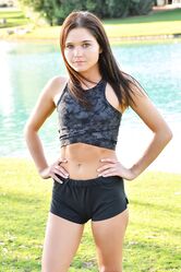 Teenage hottie in sexy outfit Zoe doing exercise outdoors by the water