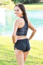 Teenage hottie in sexy outfit Zoe doing exercise outdoors by the water