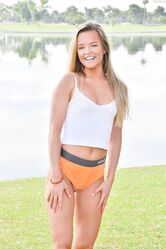 Cute teen Serena doffs her clothes to show her ass and poses in a park