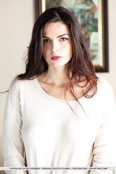 Long legged teen Cynthia Hill removes a long sleeved shirt to pose in the nude
