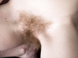 Natural redhead Ana Molly grabs her bare ass after exposing her naked bush