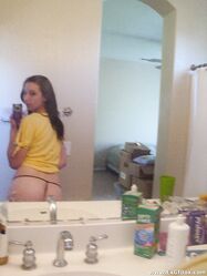 Amateur teen babe Casey posing topless in her black g-string panties