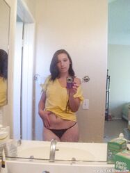 Amateur teen babe Casey posing topless in her black g-string panties