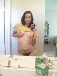 Amateur teen babe Casey posing topless in her black g-string panties