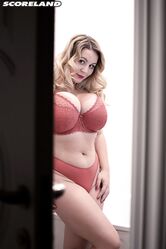 Dirty blonde Holly Garner sets her giant tits free during a bubble bath