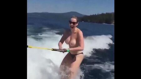 Girl rides on water skiing topless