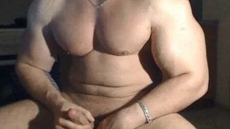 Very handsome muscular man posing and jerking off