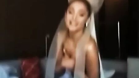Ariana Grande topless holding her boobs behind the scenes