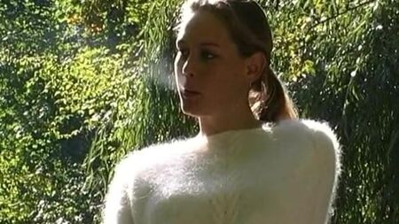 Lady with fluffy sweater smokes