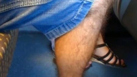 Climbed with his hand to the woman under the skirt and began to crush the vagina with his fingers