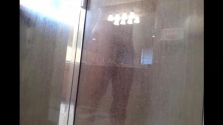 The hidden camera shoots as a man washes in the shower