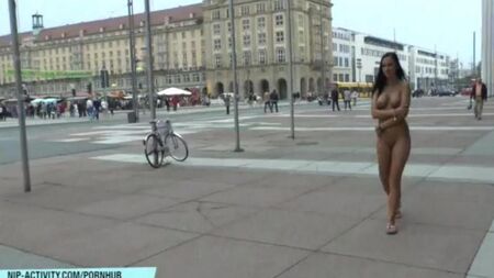 Naked chick walks the streets of the city
