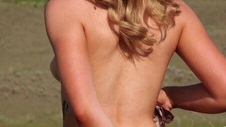 Blonde masturbates in nature