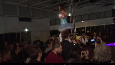 Hot brunette learns the art of striptease on a pole