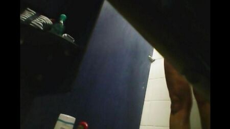 In the shower there is a hidden camera and takes off the shaved pussy of a girl