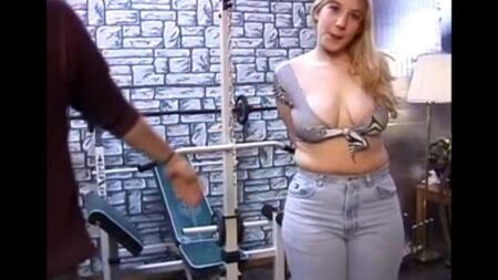 A long -haired woman with natural tits examines a man's penis